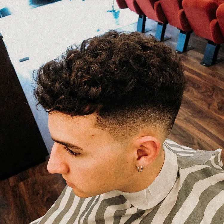  curly faux hawk with low taper fade hairstyle 