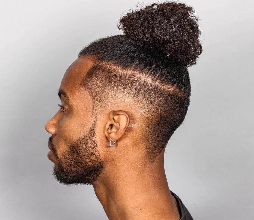 curly top knot with tapered sides 